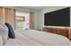 Cozy main bedroom featuring a mounted TV and access to a balcony at 1250 S Pinellas Ave # 207, Tarpon Springs, FL 34689