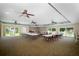 Spacious meeting room with ceiling fans, tables, chairs and natural light through large windows at 1250 S Pinellas Ave # 207, Tarpon Springs, FL 34689