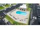 Community pool surrounded by tables and chairs, with parking and a restroom nearby at 1250 S Pinellas Ave # 207, Tarpon Springs, FL 34689
