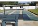 Outdoor shuffleboard courts with shaded seating for leisure and recreation at 1250 S Pinellas Ave # 207, Tarpon Springs, FL 34689