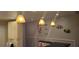 Stylish bar area with unique pendant lighting and decorative wall art enhancing the space at 12760 Indian Rocks Rd # 1049, Largo, FL 33774