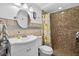 Bathroom with a glass enclosed shower, patterned shower curtain, and decorative mirror at 12760 Indian Rocks Rd # 1049, Largo, FL 33774
