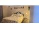 Comfortable bedroom features a quaint beach theme and charming decor at 12760 Indian Rocks Rd # 1049, Largo, FL 33774