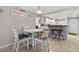 Charming dining area with seating for four adjacent to the kitchen with a breakfast bar at 12760 Indian Rocks Rd # 1049, Largo, FL 33774