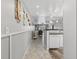 Charming hallway with tiled floors leading into a living area and showcasing coastal decorations at 12760 Indian Rocks Rd # 1049, Largo, FL 33774