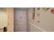 Hallway with door and decorative wall art creating an inviting and personalized space at 12760 Indian Rocks Rd # 1049, Largo, FL 33774
