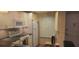 Well-organized kitchen features cream cabinets, efficient appliances, and a tiled backsplash at 12760 Indian Rocks Rd # 1049, Largo, FL 33774