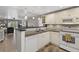 Open kitchen with a view into the living room, featuring updated appliances and a breakfast bar at 12760 Indian Rocks Rd # 1049, Largo, FL 33774