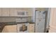 Efficient kitchen design with white appliances, tile backsplash, and ample cabinet storage at 12760 Indian Rocks Rd # 1049, Largo, FL 33774