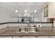 Kitchen sink with views into the dining and living areas, enhanced by pendant lighting at 12760 Indian Rocks Rd # 1049, Largo, FL 33774
