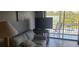 Bright living area features a comfortable sofa and large windows leading to a balcony at 12760 Indian Rocks Rd # 1049, Largo, FL 33774