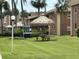 Community picnic area with BBQ grills and tropical landscaping at 12760 Indian Rocks Rd # 904, Largo, FL 33774