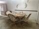 Charming dining area with a round table, four chairs, and decorative wall accents at 12760 Indian Rocks Rd # 904, Largo, FL 33774