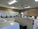 Community laundry room with multiple washers and dryers, as well as a folding table at 12760 Indian Rocks Rd # 904, Largo, FL 33774