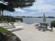 Waterfront seating area with tables and lounge chairs with a clear view of the bay at 12760 Indian Rocks Rd # 904, Largo, FL 33774