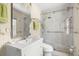 Updated bathroom featuring a walk-in shower with marble surround and grab bars at 13684 Orange Sunset Dr # 101, Tampa, FL 33618