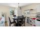 Dining area featuring a chandelier, modern furniture, and adjacent kitchen space at 13684 Orange Sunset Dr # 101, Tampa, FL 33618