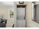 Convenient laundry area with stacked washer and dryer, located near the dining space at 13684 Orange Sunset Dr # 101, Tampa, FL 33618