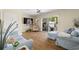 Cozy living room with a ceiling fan, wood floors, and sliding glass doors to an outdoor area at 13684 Orange Sunset Dr # 101, Tampa, FL 33618