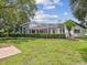 Backyard view featuring a large screened pool, landscaping and nice lawn at 18803 Misty Shores Ln, Lutz, FL 33548