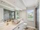 Modern bathroom featuring a unique glass sink, a large mirror, and a glass-enclosed shower at 18803 Misty Shores Ln, Lutz, FL 33548