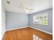 This bedroom features a ceiling fan and a window with shutters that provides plenty of natural light at 18803 Misty Shores Ln, Lutz, FL 33548
