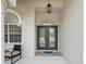 The beautiful, glass front doors offer a grand entrance to the home at 18803 Misty Shores Ln, Lutz, FL 33548