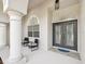 The home features a covered entry with glass front doors and beautiful sidelight windows at 18803 Misty Shores Ln, Lutz, FL 33548