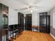 Home office with hardwood floors, ceiling fan, built-in bookshelves, and desk at 18803 Misty Shores Ln, Lutz, FL 33548