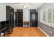 Home office with hardwood floors, ceiling fan, built-in bookshelves, desk, and natural light at 18803 Misty Shores Ln, Lutz, FL 33548