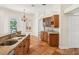 Open concept kitchen with a double sink island, wood cabinets and tile floors at 18803 Misty Shores Ln, Lutz, FL 33548