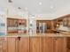 Spacious kitchen featuring granite countertops, wood cabinetry, and stainless steel appliances at 18803 Misty Shores Ln, Lutz, FL 33548