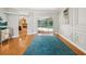 Living room showing hardwood floors, bright lighting, and a view to the backyard pool at 18803 Misty Shores Ln, Lutz, FL 33548