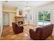 Inviting living room features a cozy stone fireplace and sliding doors leading to a screened pool area at 18803 Misty Shores Ln, Lutz, FL 33548