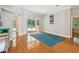 This living room features wood flooring, and a sliding door to the outdoor pool at 18803 Misty Shores Ln, Lutz, FL 33548