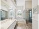 Bright bathroom featuring a double vanity, soaking tub, and a walk-in shower at 18803 Misty Shores Ln, Lutz, FL 33548