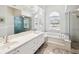 Bright bathroom with double vanity, soaking tub, and walk-in shower at 18803 Misty Shores Ln, Lutz, FL 33548