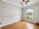 Bright office with wood floors, chair rail, and large window providing natural light at 18803 Misty Shores Ln, Lutz, FL 33548