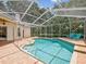 Inviting screened-in pool area with brick patio and comfortable seating at 18803 Misty Shores Ln, Lutz, FL 33548