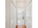 Walk-in closet with double doors leading to an ensuite bathroom at 18803 Misty Shores Ln, Lutz, FL 33548