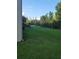 Spacious backyard with a well-manicured lawn and a partial view of the property's surroundings at 19239 Stone Hedge Dr, Tampa, FL 33647