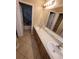 Bathroom with a dual sink vanity and a tub/shower combo with dolphin shower curtain at 19239 Stone Hedge Dr, Tampa, FL 33647