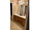 Bathroom with tile flooring, a double vanity with wood cabinets, and a large mirror at 19239 Stone Hedge Dr, Tampa, FL 33647