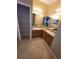 Bright bathroom featuring dual sinks, wooden cabinets, and a storage closet at 19239 Stone Hedge Dr, Tampa, FL 33647