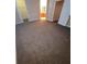 A carpeted bedroom with open doorways leading to a bathroom and closet at 19239 Stone Hedge Dr, Tampa, FL 33647