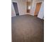 Spacious carpeted bedroom featuring multiple doorways, enhancing accessibility at 19239 Stone Hedge Dr, Tampa, FL 33647