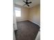 Carpeted bedroom with a ceiling fan and a window for natural light at 19239 Stone Hedge Dr, Tampa, FL 33647