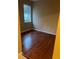 Bedroom with hardwood floors, a large window, and neutral colored walls at 19239 Stone Hedge Dr, Tampa, FL 33647