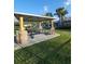 Outdoor community picnic area with a grill, picnic tables, and stone accents at 19239 Stone Hedge Dr, Tampa, FL 33647