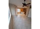 Open dining area with tile flooring, leading to the kitchen area, and large windows at 19239 Stone Hedge Dr, Tampa, FL 33647